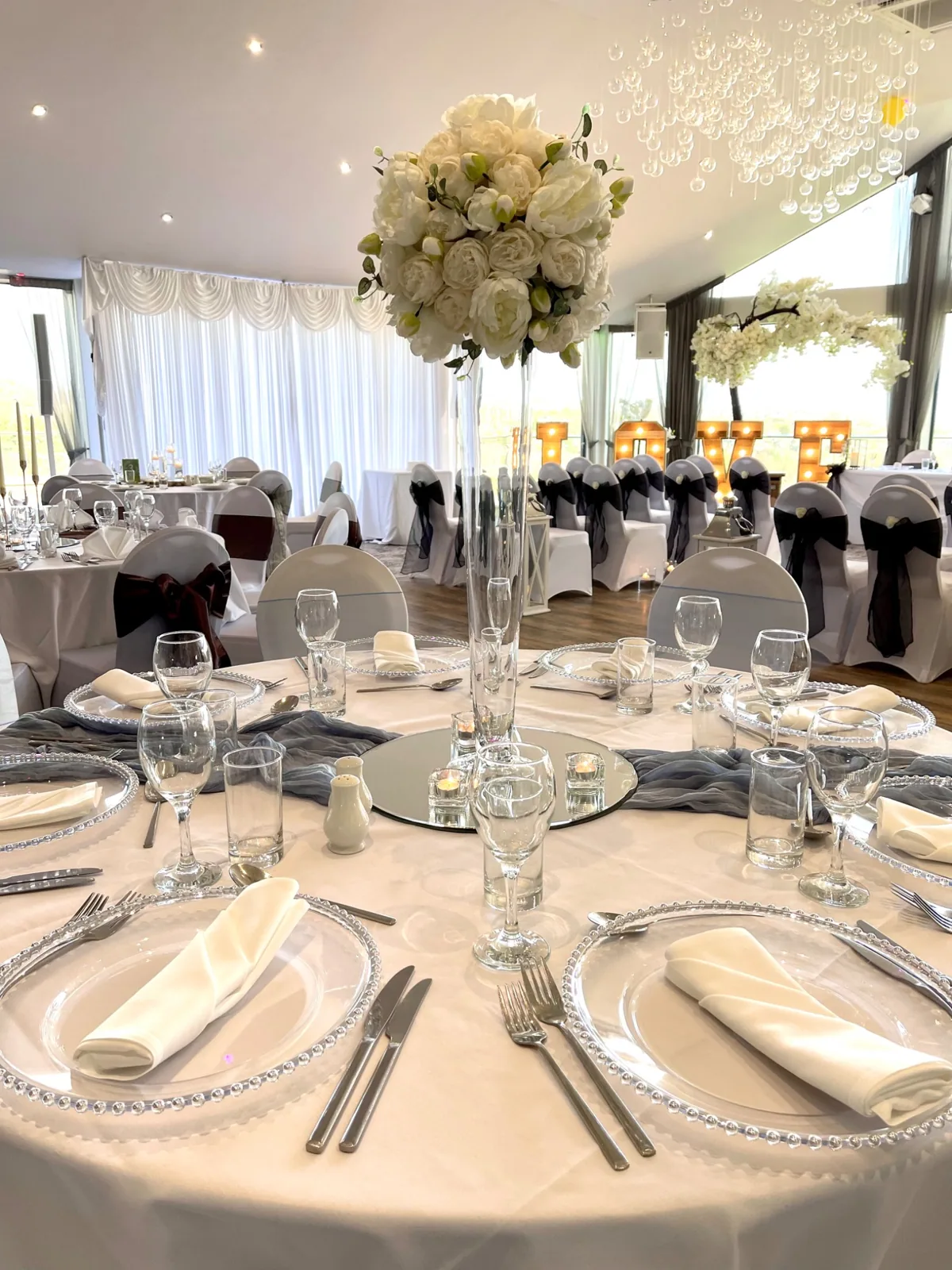 White floral centrepiece with blue table runner